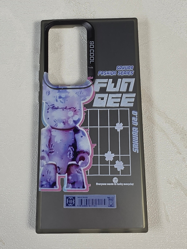 قاب نیمه شفاف دودی گوشی سامسونگ S23 Ultra با طرح گرافیکی خرس بنفش Bearbrick و نوشته Sakura Fashion